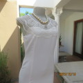 Luxury  cream poly/rayon mini lined dress .Stunning netting/embroidered neckline.Size 32 by RYAN N.Y