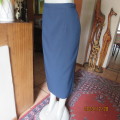 Elegant ankle length navy no stretch polyester pencil skirt size 36/12. Zip/slit at back. New cond.