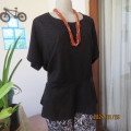 Lovely black peplum slip over top in jacquard knit stretch polyester. Patterned. By DONNA CLAIRE. 48