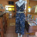 Make a statement in this navy ankle length strappy jumpsuit with floral pattern. Size 36/12. As new