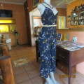 Make a statement in this navy ankle length strappy jumpsuit with floral pattern. Size 36/12. As new