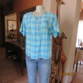 Striking checked short sleeve polycotton top in shades of blues with black/silver stripes.Size 38.