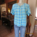 Striking checked short sleeve polycotton top in shades of blues with black/silver stripes.Size 38.