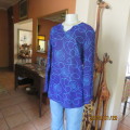 Make a statement in this indigo blue long sleeve top with turquoise twirls.Size 36.By FOSHINI.As new