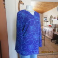 Make a statement in this indigo blue long sleeve top with turquoise twirls.Size 36.By FOSHINI.As new