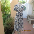 Stunning ankle length empire top steel blue/white poly/nylon dress.Side straps.Bell sleeves. Size 36