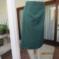 Smart dark green bottle green fully lined pencil size 36 skirt. With pleat and zip at back. As new.
