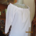 Sweet off the shoulder top with elbow length raglan sleeves in white. Polycotton stretch fabric. 36.