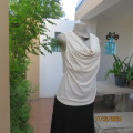 Up the lux with this rich cream slip over cowl neck stretch polyester top.Strappy underlay.Size 36.