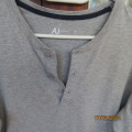 As new Men`s grey long sleeve T-Shirt in 100% cotton.Opening on front with 3 buttons. By AU. 87/94cm