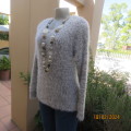 Warm fluffy silver grey polyester knit long sleeve sweater by KELSO size 36/12. In new condition.