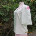 Amazing mint green silk blouse with short sleeves . Hidden button down.Luxe embroidery.By BONITA 35.