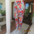 Cheerful crimson/lilac/green bold floral pattern poly stretch pants. Wide elastic waistband.Size 42.