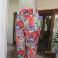 Cheerful crimson/lilac/green bold floral pattern poly stretch pants. Wide elastic waistband.Size 42.