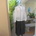 Optic white long sleeve button down top. Two wide tucked seams. Polyester. Chinese collar.Size 38