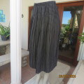 Easy wear black yoked knife pleated silky polyester skirt with white polka dots.Size 42. WOOLWORTHS