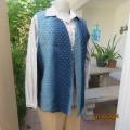 High class sleeveless waistcoat in blue shades. Back fine corduroy/front firm with holes.Size 37.
