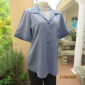 Boutique made short sleeve button down top/jacket in blues. Polyester/viscose. Size 38. One pocket.