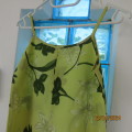 Long green polyester dress with dark green leaves. Bust 75cm/82cm hips. For 12yr old. As new