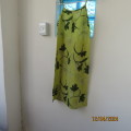 Long green polyester dress with dark green leaves. Bust 75cm/82cm hips. For 12yr old. As new