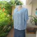 Soft sky blue button down V neck short sleeve top. With tiny white flowers. 100% viscose/ Size 40.