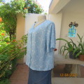 Soft sky blue button down V neck short sleeve top. With tiny white flowers. 100% viscose/ Size 40.