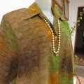 The fabric says it all!! Stunning button down top in medley of green/brown/rust. Size 48. New cond.