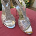 Pair of silver high heel SOLO size 6 open toe sandals. Zip at back. FAUX diamond straps. Used once.
