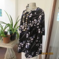 Fabulous slip over black with white/purple flowers short sleeve poly stretch top.DONNA CLAIRE 44.