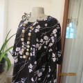 Fabulous slip over black with white/purple flowers short sleeve poly stretch top.DONNA CLAIRE 44.