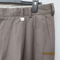 As new Men`s fashion pants in coffee brown polyester/rayon blend. Pleats on front.Size 38. JONTY`S