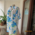 Get noticed in this white short sleeve top with bold blue/green flowers.Size 42. New cond.