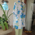 Get noticed in this white short sleeve top with bold blue/green flowers.Size 42. New cond.