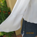 Pretty white polyester slip over top with long sleeves/flare cuffs. Front braided opening.Size 38/40