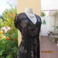 Fabulous black/graphic bold cream floral pattern elasticated empire dress.By REITMANS Canada size 40
