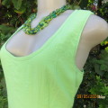 Cool bright apple green empire dress in creased polyester size 34. Sleeveless/scooped neckline.