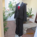 Smart black/white pinstripe pantsuit. Long sleeve button down lined jacket.Bootlcut pants.Size 37/13