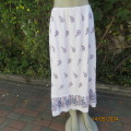 Easy to wear white 100% textured rayon purple floral print long skirt. Size 40. Elastic waist.