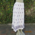 Easy to wear white 100% textured rayon purple floral print long skirt. Size 40. Elastic waist.