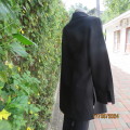 Smart long black jacket/top. Long cuffed sleeves. Size 40. Button down/open collar. New conditon.