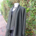 Well-cut hunters green long wool cape with mustard/red accents.Genuine leather corners.Size 34 to 38