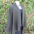 Well-cut hunters green long wool cape with mustard/red accents.Genuine leather corners.Size 34 to 38