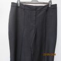 Stunning dress pants in black polyester with vague grey check. By ZETA size 44/20. Brand new cond.