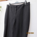 Stunning dress pants in black polyester with vague grey check. By ZETA size 44/20. Brand new cond.