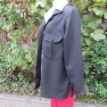 Versatile black jacket with long cuffed sleeves. In textured polyester.Front pockets. Size 38.As new