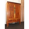 AN INCREDIBLE ANTIQUE DOUBLE DOOR CHINESE CABINET WITH TRADITIONAL HANDLES AND HINGES AND A DRAWER