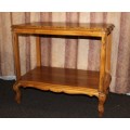 A FANTASTIC BURMESE TEAK DOUBLE SHELF SERVING HATCH TABLE WITH AMAZING HAND CARVED DETAILING