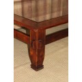 AN EXQUISITELY CRAFTED SOLID WOODEN CENTER COFFEE/ OCCASIONAL TABLE WITH A TOUGHENED GLASS TOP