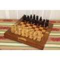 A SUPERB VINTAGE HAND-CARVED ORIENTAL FOLDING CHESS BOARD AND CARVED CHESS SET IN AWESOME CONDITION