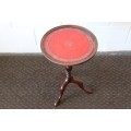 A stunning Victorian antique mahogany occasional table w/ a leather clad top and scalloped rim